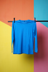Blue t-shirt mockup hanging over colorful background