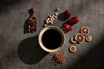 Obraz na płótnie Canvas Anise, lotus seed, dried red apple, dried fruit and cordyceps are the ingredients in this nutritious herbal tea. 