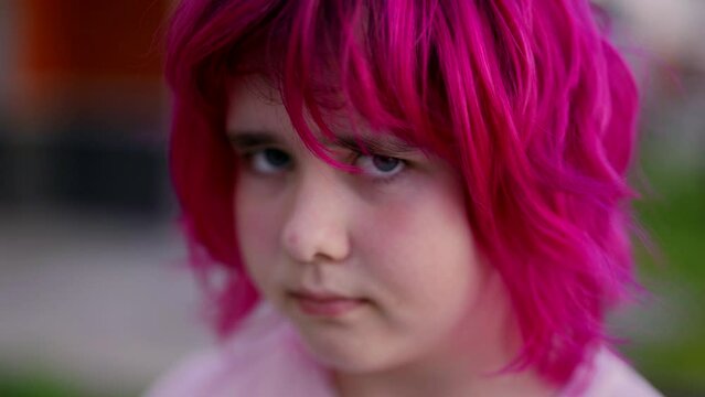 portrait of cute teen girl with colored pink hair, looks at camera, difficult teenage