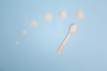 The concept of medicine, healthcare and diabetes - a spoon with sugar