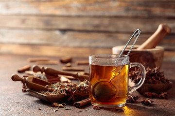 Christmas herbal tea with cinnamon, anise, and dried herbs. - obrazy, fototapety, plakaty