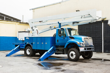 Front and side view of parked power utility truck.