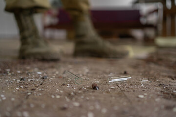 Nuclear apocalypse survivor, soldier in the destroyed laboratory building, legs close-up. nuclear...