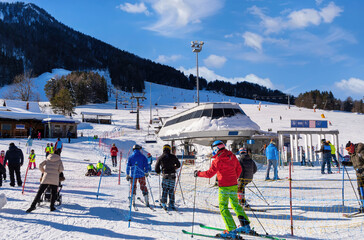 People skiing on slopes in winter scenery in Kranjska Gora in Julian alps, Slovenia