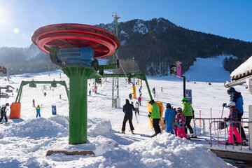 People skiing on slopes in winter scenery in Kranjska Gora in Julian alps, Slovenia