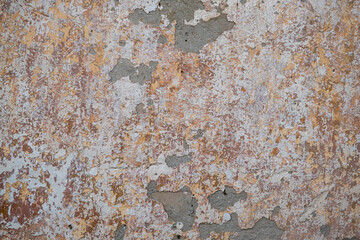 The texture of the old plaster on the wall of the house. Stylish vintage background