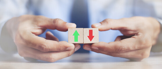 businessman hand  arranging wood block stacking as step stair with arrow up.concept for business growth success process.