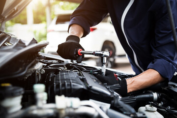 Automobile mechanic repairman hands repairing a car engine automotive workshop with a wrench, car service and maintenance , Repair service