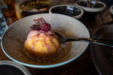 Delicious dessert with raspberry and chocolate chips on top in a bowl