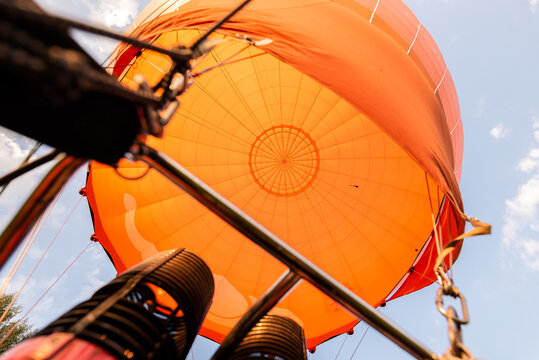Inside of orange Hot air balloon, photographed from within during flight.
