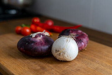 red and white onions on a wooden cutting board