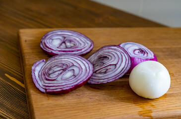 sliced onions on a wooden cutting board