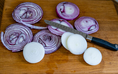 sliced onions on a wooden cutting board