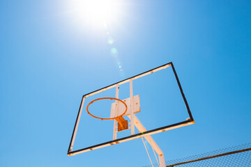 Broken backboard of basketball field in the park. Abandoned town concept photo