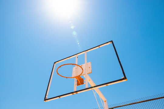 Broken backboard of basketball field in the park. Abandoned town concept photo