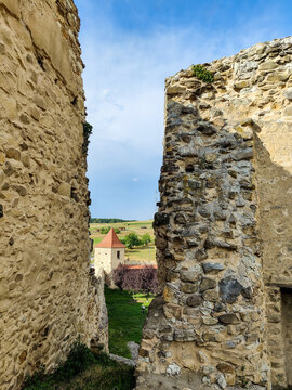 View of old tower from observation deck of ancient Rupea fortress in Romania against blue sky with clouds. Fortress was built on ruins of former Dacian defensive structure. Copy space. 