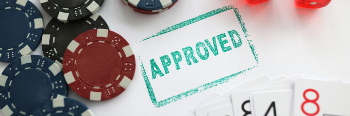 Stamp approved standing near playing cards and chips in casino with dice closeup
