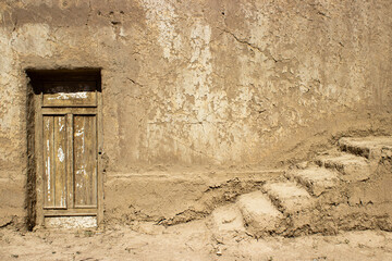 old wooden door of an oriental clay house