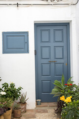 Picturesque blue door in the town of Frigiliana located in mountainous region of Malaga, 