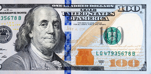 Macro shot of a new 100 dollar bill. A detailed picture of US money for financial, economic and...