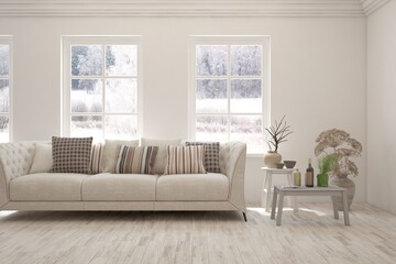 Modern living room in white color with sofa and winter landscape in window. Scandinavian interior design. 3D illustration