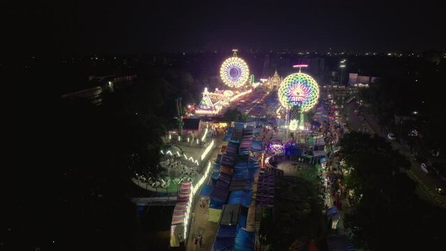 Aerial view of Giant Wheels at Indian fair, Ferris wheel in mela, drone view