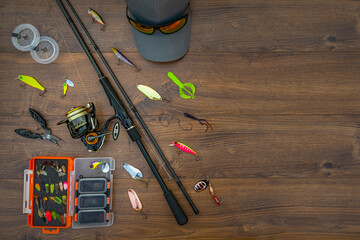 Spinning fishing tackle set. Spinning rod with reel, lures, baits, spoon, spinner, hooks, cap,...