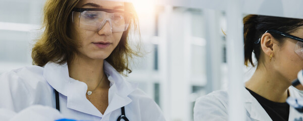 Close up portrait of female researcher, medical scientist or doctor in laboratory