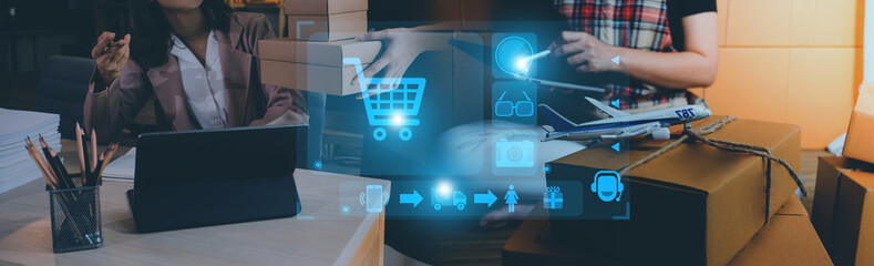 Startup small business entrepreneur or freelance Asian woman using a laptop with box, Young success Asian woman with her hand lift up, online marketing packaging box and delivery, SME concept.