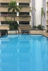 Fototapeta na wymiar well-being pool area near condominium, tropic climate architecture, vertical