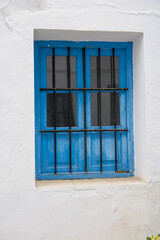 Picturesque blue window in the town of Frigiliana located in mountainous region of Malaga, 