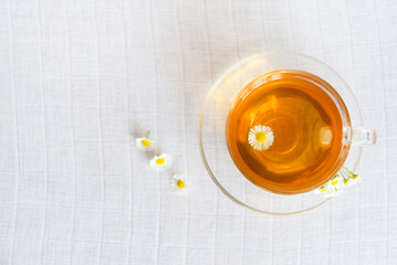 cup of herbal tea with chamomile flowers	