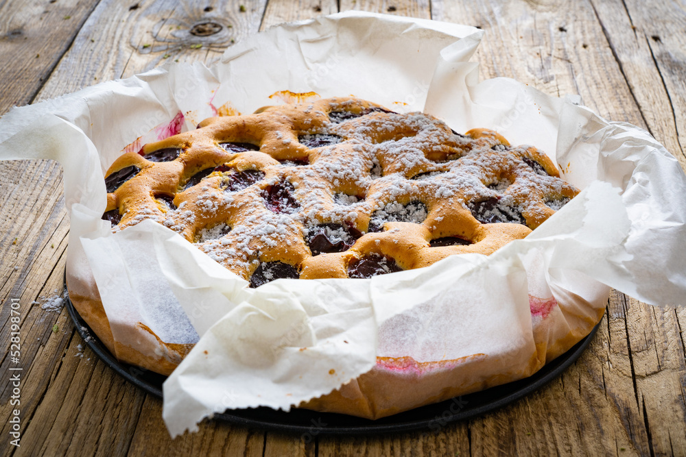 Wall mural Fruit cake on wooden table
