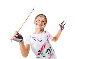 child girl in colorful paint holding brush in one hand