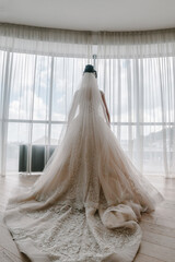 Portrait of a beautiful stylish bride with an elegant dress view from the back. Wedding, people, fashion and beauty concept - bride in wedding dress. Back view.