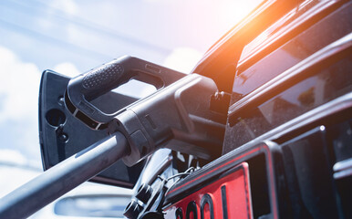 Charging electric car from station at the city street