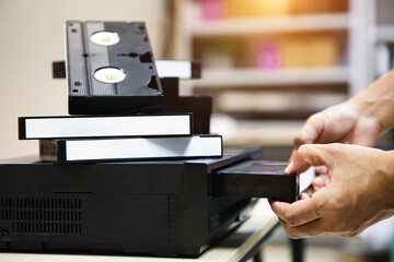 Close-up hand putt playback button on video record player concept of retro style or vintage electric and electronic appliances multimedia playback device old fashioned.