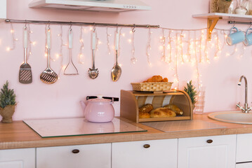 modern kitchen interior. new year and christmas decorations with decorative lamps.