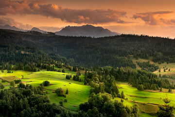 View of the Tatra Mountains from Osturna in Slovakia. Summer, mountain, glade. Widok na Tatry z Osturni na Słowacji. Lato, góra, polana. 
