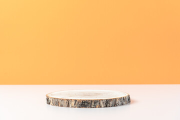 Wood cut podium on orange background. Concept scene stage showcase, product, promotion sale, presentation, beauty cosmetic. Wooden stand studio empty
