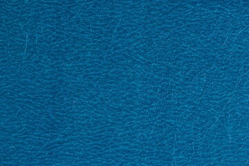 Abstract design background of glossy artificial genuine textured deep blue creased leather. Flat surface. Skin natural wrinkled scratched wallpaper winter sale pattern. Close-up, mock up, top view