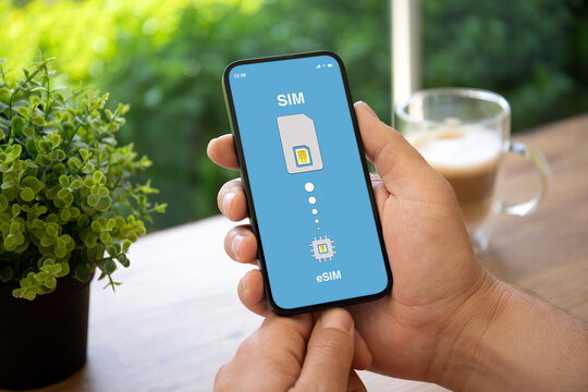 man hands holding phone with Sim card replacement on eSim