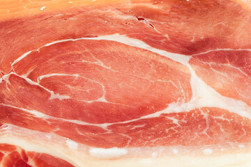 Slices of dried spanish ham. Jamon Serrano. Flat lay. Close up of meat slice. Meat textured...