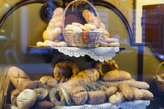 Pastries, bread, buns on a shop window through glass