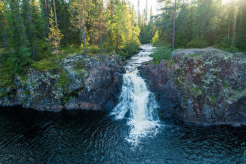 Beautiful Komulanköngäs waterfall on a summer evening. Shot near Hyrynsalmi, Northern Finland. 
