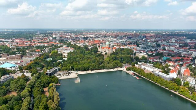 New Town Hall (Neues Rathaus) and Hannover city center aerial view, Germany, Europe. Aircraft point of view aerial shot ft. Maschsee Lake and parks around Hanover-Mitte, the historic heart of the city