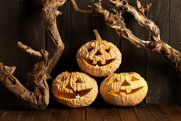 Halloween pumpkin glows on old wooden background.