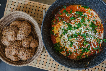 Sakshuka in the pan and brown bread hallah