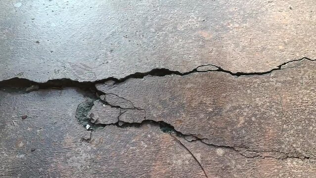 Cracked concrete ground broken at floor home or street road subside from earthquake_2