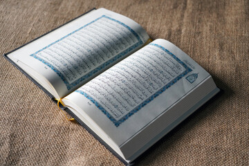 Indonesia - July, 2022 : The Quran, also romanized Qur'an or Koran, is central religious text of...